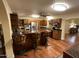 Spacious kitchen featuring stainless steel appliances, wooden cabinets, dark counters, and a center island with bar seating at 7216 W Country Gables Dr, Peoria, AZ 85381