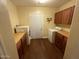 Functional laundry room with washer, dryer, wooden counters, and cabinet storage at 7216 W Country Gables Dr, Peoria, AZ 85381