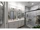 This modern bathroom features double sinks, a walk-in shower and stylish tile at 738 W Kingman Dr, Casa Grande, AZ 85122