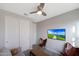 Comfortable bedroom featuring a gray sofa, a leather chair, and a mounted television for a relaxing atmosphere at 738 W Kingman Dr, Casa Grande, AZ 85122