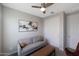 Relaxing bedroom featuring a gray sofa, a leather chair, and abstract art creating a serene and inviting space at 738 W Kingman Dr, Casa Grande, AZ 85122