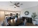 Bright dining area with a dark wood table and seating for six, open to the kitchen and adjacent to modern buffet at 738 W Kingman Dr, Casa Grande, AZ 85122