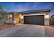 Single-story home featuring stone accents, a paver driveway, and a two-car garage nestled within a well-kept lawn at 738 W Kingman Dr, Casa Grande, AZ 85122