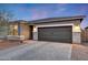 Charming single-story home with stone accents, a paver driveway, and a two-car garage creates a welcoming curb appeal at 738 W Kingman Dr, Casa Grande, AZ 85122