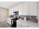 A kitchen boasting sleek white cabinets, modern appliances, and ample counter space for cooking, prep, and entertaining at 738 W Kingman Dr, Casa Grande, AZ 85122