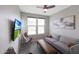 A cozy living room with a gray sofa, a unique leather chair, and large windows offering ample natural light at 738 W Kingman Dr, Casa Grande, AZ 85122