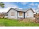 View of the back of the house and yard with grass and a brick perimeter wall at 8027 E Quarterline Rd, Mesa, AZ 85207