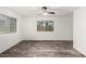 Well-lit bedroom features wood-look flooring, ceiling fan, and a serene, minimalist design at 8027 E Quarterline Rd, Mesa, AZ 85207