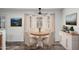 Inviting dining area with bay window, wood-look flooring, complemented by a charming round table and tasteful decor at 8027 E Quarterline Rd, Mesa, AZ 85207