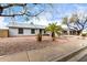 An exterior shot of a single-story home with desert landscaping and a tidy, well-maintained front yard at 8027 E Quarterline Rd, Mesa, AZ 85207