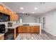 Well-lit kitchen featuring wooden cabinets, sleek black appliances, and seamless open floorplan at 8027 E Quarterline Rd, Mesa, AZ 85207