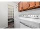 Bright laundry room features a washer, dryer, shelving, and storage cabinets at 8027 E Quarterline Rd, Mesa, AZ 85207