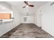 Bright, open living space showcasing stylish wood flooring, opening to kitchen with bar seating at 8027 E Quarterline Rd, Mesa, AZ 85207