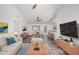 Staged living room with wood floors, ceiling fan, breakfast bar, with modern furnishings creating a welcoming space at 8027 E Quarterline Rd, Mesa, AZ 85207