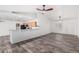 Open concept living area with wood floors, bar seating, opening to a view of kitchen cabinets at 8027 E Quarterline Rd, Mesa, AZ 85207