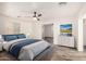 Stylishly decorated main bedroom showcasing contemporary furniture, wood-look flooring, and soft lighting at 8027 E Quarterline Rd, Mesa, AZ 85207