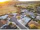 Stunning aerial view of a neighborhood with nearby park and sports fields at sunset at 8114 E Arlington Rd, Scottsdale, AZ 85250