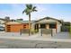 Inviting single-story home featuring a modern garage, xeriscaping, and a cozy seating area on the front porch at 8114 E Arlington Rd, Scottsdale, AZ 85250