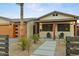 Close-up of a home highlighting the modern garage, desert landscaping, and charming front porch at 8114 E Arlington Rd, Scottsdale, AZ 85250