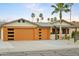 Beautiful single-story home with modern garage doors, desert landscaping, and a welcoming front porch at 8114 E Arlington Rd, Scottsdale, AZ 85250