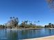 Peaceful lake view with island and palm trees on a clear day at 8114 E Arlington Rd, Scottsdale, AZ 85250