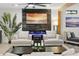 Well-lit living room with hardwood floors, a fireplace and lots of comfortable seating at 8114 E Arlington Rd, Scottsdale, AZ 85250