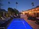 Relaxing backyard at dusk with pool, spa, outdoor seating, and outdoor kitchen at 8114 E Arlington Rd, Scottsdale, AZ 85250