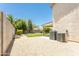 Spacious backyard featuring a lush green lawn, mature trees, and a gravel area for low-maintenance landscaping at 8163 E Posada Ave, Mesa, AZ 85212
