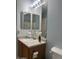 Bright bathroom with a well-lit vanity, a large mirror, and neutral colored wall at 8163 E Posada Ave, Mesa, AZ 85212