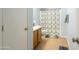 Cozy bathroom featuring a shower with patterned curtain and wood vanity at 8163 E Posada Ave, Mesa, AZ 85212