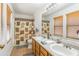 Bright bathroom with double sinks and wood-framed mirrors at 8163 E Posada Ave, Mesa, AZ 85212