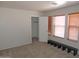 Neutral bedroom featuring two windows with wood blinds and an open closet for ample storage at 8163 E Posada Ave, Mesa, AZ 85212