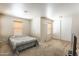 Relaxing bedroom with carpeted floors, modern window blinds and a stylish bed at 8163 E Posada Ave, Mesa, AZ 85212