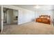 Spacious bedroom with carpeted floors and a stylish wood bed frame at 8163 E Posada Ave, Mesa, AZ 85212