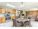 Cozy dining area flows into the living room and kitchen, featuring warm lighting and wooden cabinetry at 8163 E Posada Ave, Mesa, AZ 85212