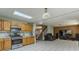 Kitchen with stainless steel appliances, wood cabinets, and an open layout leading to the living area at 8163 E Posada Ave, Mesa, AZ 85212