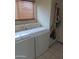 Bright laundry room with a washer and dryer set and a window for natural light with tile flooring at 8163 E Posada Ave, Mesa, AZ 85212