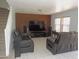 Living room with tile floors, modern leather sofas, television and speakers at 8163 E Posada Ave, Mesa, AZ 85212