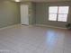 Spacious living room with tile floors, a front door and a large window at 8163 E Posada Ave, Mesa, AZ 85212