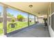 Large covered patio overlooking a lush backyard with mature trees at 8163 E Posada Ave, Mesa, AZ 85212