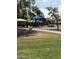 Community playground featuring modern play structures, shaded picnic area, and lush landscaping at 8163 E Posada Ave, Mesa, AZ 85212