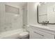 A renovated bathroom with new fixtures, a shower-tub combo, and marble-look tiling at 833 S Toltec --, Mesa, AZ 85204