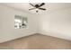 Neutral bedroom featuring tiled floors, a ceiling fan, and a large window at 833 S Toltec --, Mesa, AZ 85204