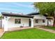 Attractive home featuring manicured lawn, contrasting black trim and a mature shade tree at 833 S Toltec --, Mesa, AZ 85204