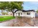 Lovely home boasting a patterned brick driveway, well-manicured lawn, and modern outdoor lighting at 833 S Toltec --, Mesa, AZ 85204