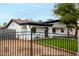 Stylish home showcasing a decorative fence and a lush green lawn, enhancing curb appeal at 833 S Toltec --, Mesa, AZ 85204