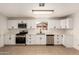 Updated kitchen featuring stainless steel appliances and bright white cabinetry at 833 S Toltec --, Mesa, AZ 85204