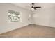 Bright living room featuring tile floors, fresh paint, and a modern ceiling fan at 833 S Toltec --, Mesa, AZ 85204