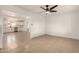 Open-concept living area with tile flooring flowing into a kitchen with white cabinetry at 833 S Toltec --, Mesa, AZ 85204