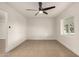 Clean and spacious living room featuring neutral tile flooring, modern ceiling fan, and fresh paint at 833 S Toltec --, Mesa, AZ 85204